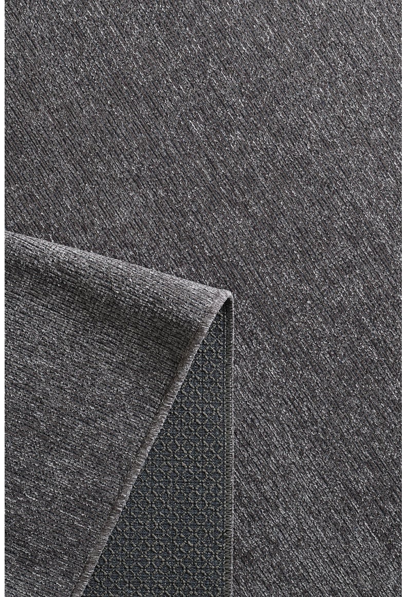 A close-up of the Velvet Touch Dark Gray Area Rug - PST004 reveals its subtle diagonal texture and non-slip diamond grid backing, making it ideal for fans of modern rugs and minimalist design.