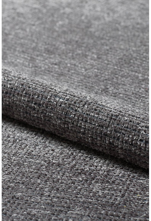 Load image 1 in gallery view. A close-up of the Velvet Touch Dark Gray Area Rug - PST004 highlights its soft, textured gray fabric with a subtle grid pattern, slightly reflective surface, and minimalist appeal—perfect for modern interiors.