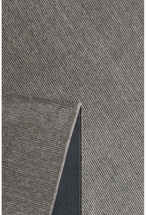 Load image 1 in gallery view. A close-up of the Velvet Touch Gray Area Rug - PST003 shows its textured diagonal pattern and a folded corner revealing the dark non-slip backing—ideal for adding minimalist style to your space.