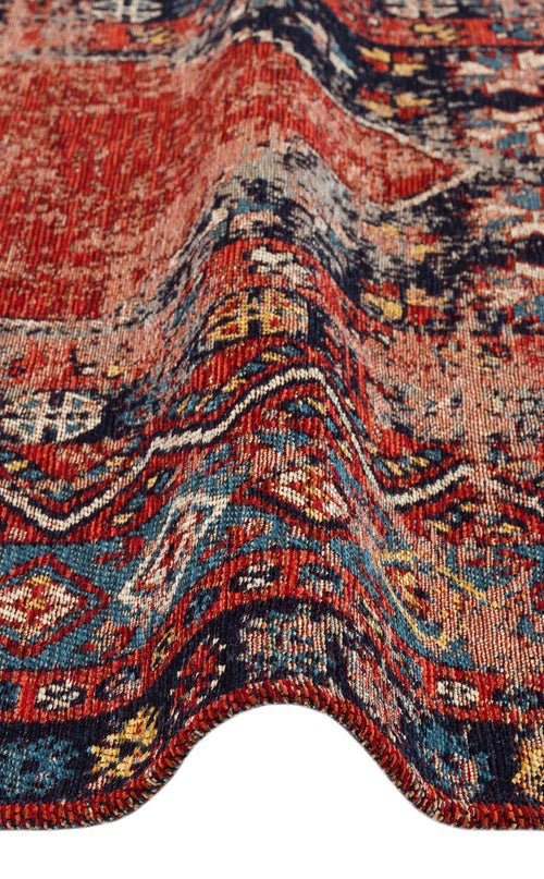 Load image 1 in gallery view. Close-up of the Vintage Echo - Washable Kilims - AND04 chenille-polyester rug, showcasing its red, blue, and yellow vintage-inspired patterns with a wavy fold that highlights the detailed texture