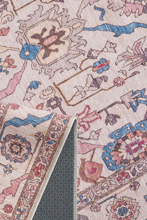 Load image 1 in gallery view. A close-up of the Vivencia Authentic Washable Rug - LCC3016 (Outlet) US in light tones with blue, pink, and beige patterns, showing a flipped corner to reveal its textured, non-slip backing.