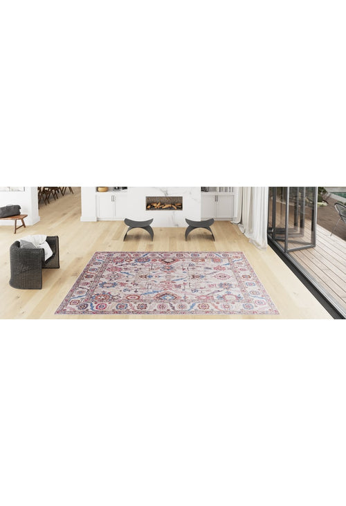 Load image 1 in gallery view. A bright, modern living room with light wood floors, a Vivencia Authentic Washable Rug - LCC3016 (Custom Size) in colorful patterns, a wicker chair with a white blanket, two black stools, and glass doors—ideal for allergy-sensitive homes.