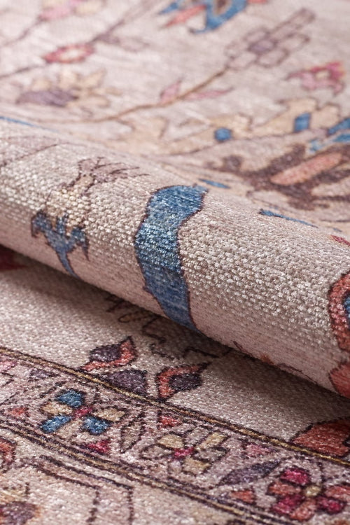Load image 1 in gallery view. Close-up of the Vivencia Authentic Washable Rug - LCC3016 (Custom Size), showing its pinkish-beige background and detailed blue, brown, cream, and red floral-geometric patterns. Washable and ideal for allergy-sensitive homes; texture and design are clearly visible.