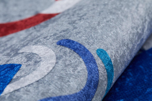 Load image 1 in gallery view. Close-up of the WaveVenture - Machine-Washable Rug JRC087 (Custom Size) in gray with abstract blue, teal, white, and red curves. Partially folded to show its plush surface—ideal for vibrant style in high-traffic areas.