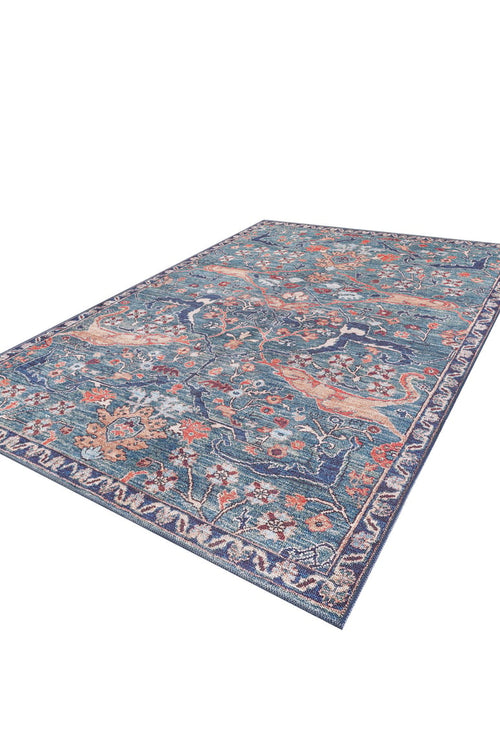 Load image 1 in gallery view. The Whisper Authentic Blue Washable Rug - LCC3034 features a rectangular blue design with intricate orange, cream, and green floral and vine patterns plus a detailed border. Shown angled on white, it's perfect for high-traffic spaces.