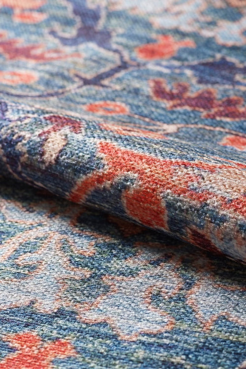 Load image 1 in gallery view. Close-up of the Whisper Authentic Blue Washable Rug - LCC3034 (Custom Size), featuring orange floral and leaf designs with detailed woven texture—ideal for high-traffic areas due to its durable, easy-to-clean construction and intricate patterns.