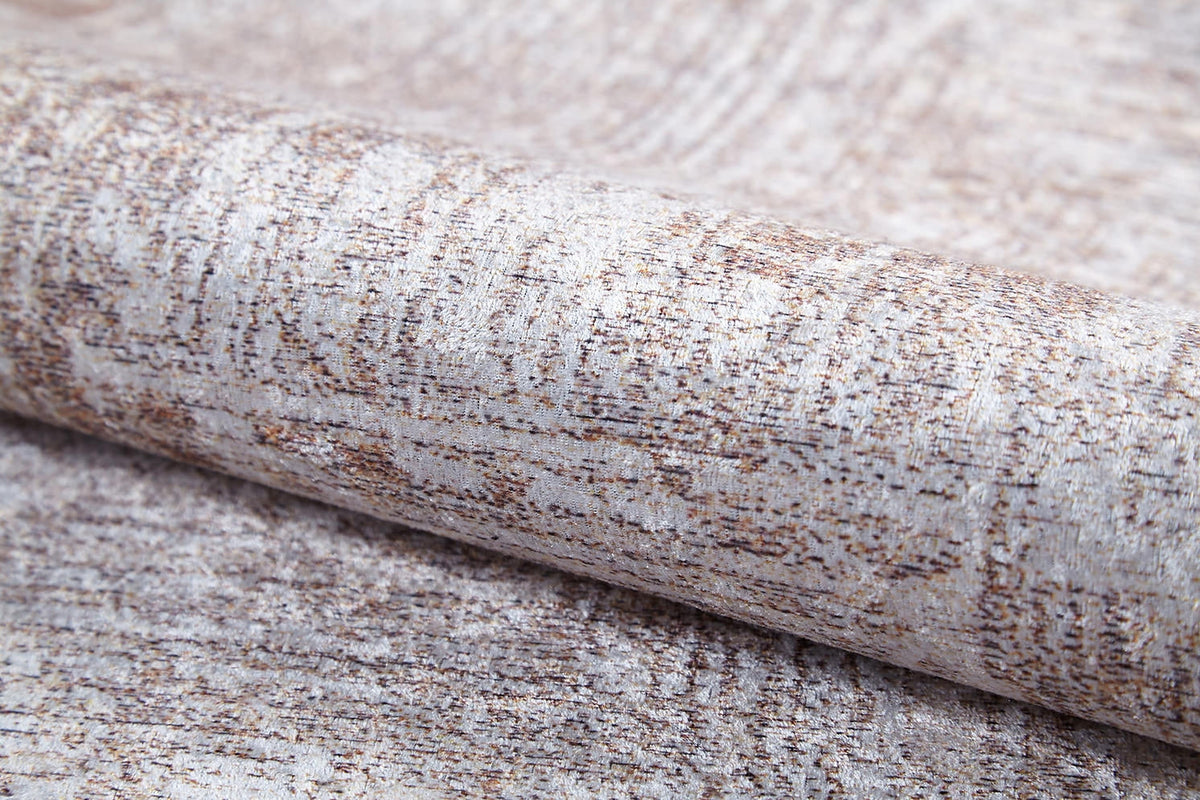 A close-up of the Wildflower Fields - Washable Rug - JR1632 (Custom Size) shows its light beige and brown mottled pattern, subtle woven texture, and a hint of metallic sheen in the flat weave fabric.