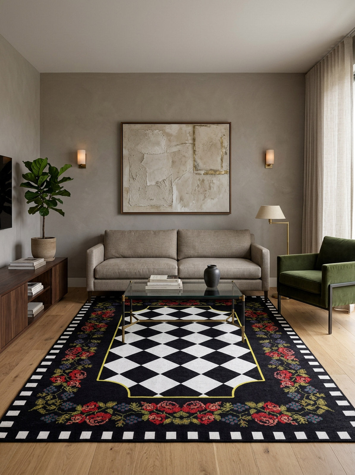 A modern living room with a beige sofa, green armchair, glass coffee table, abstract wall art, potted plant, and the Wildflower Wonderland - Washable Rug - JR587: black with geometric diamonds and red rose borders—ideal for high-traffic areas.