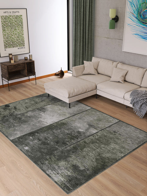 Load image 1 in gallery view. A modern living room with a light sectional sofa, neutral cushions, the Wistful Pattern - Washable Rug - JRN35 (Custom Size) in gray and green, a wooden console table, green curtains, and framed artwork on the walls.