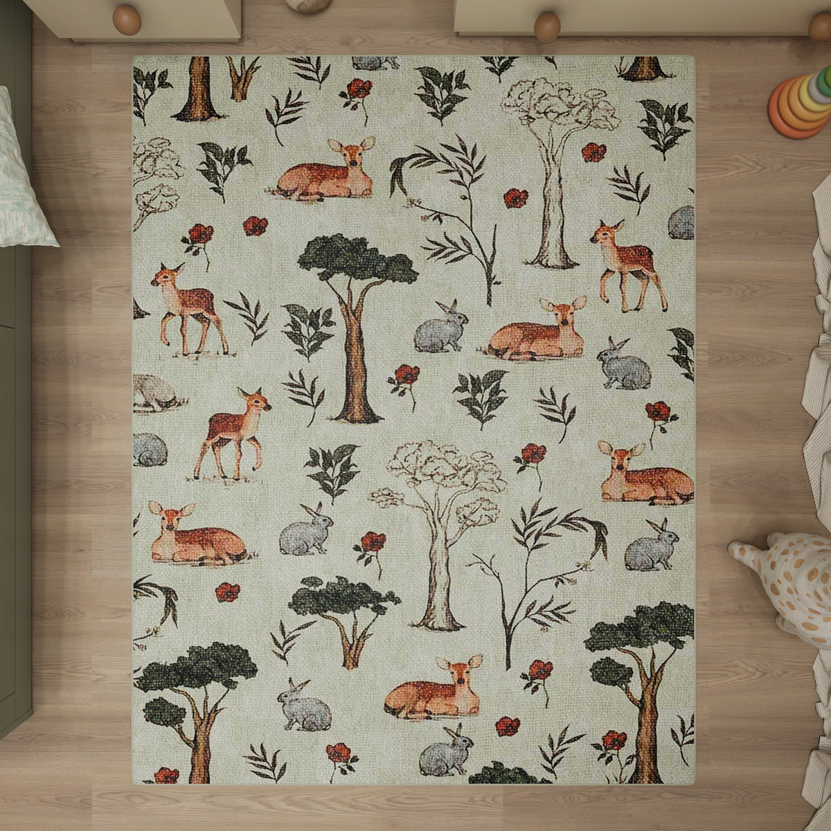 Light green rug with a woodland pattern of deer, rabbits, trees, and red flowers, styled in a nursery setting.