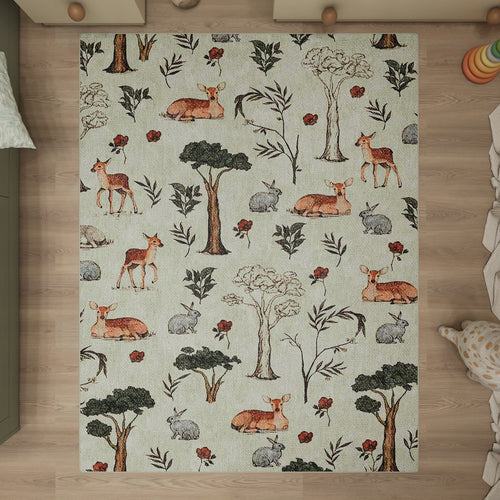 Bild 1 in Galerieansicht laden. Light green rug with a woodland pattern of deer, rabbits, trees, and red flowers, styled in a nursery setting.