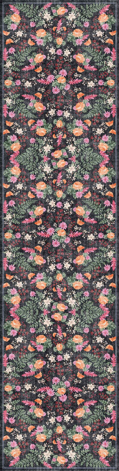 Load image 1 in gallery view. The Woven Grace - Washable Rug - JRN28 features a vibrant, symmetrical floral pattern in pink, orange, yellow, and green on a dark background—combining stylish design with durability in a long, narrow flat weave.