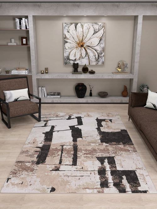 Load image 1 in gallery view. A modern living room with a brown chair and sofa, minimalist shelves with decor, a large white flower painting above the shelves, and the Woven Memoir - Washable Rug - JRN41 as a flat weave rug.
