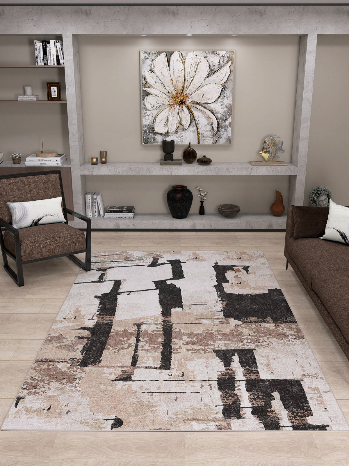 Modern living room with the Woven Memoir - Washable Rug - JRN41 (Custom Size) in beige, black, and taupe—ideal for high-traffic areas—paired with a brown sofa, armchair, sleek shelves with decor, and a striking white floral painting.