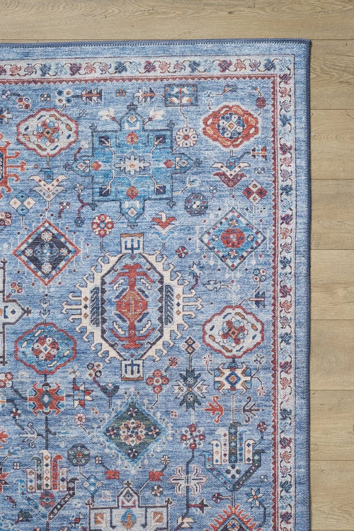 Load image 1 in gallery view. The Xanadu Handmade-Design Blue Washable Rug - LCC3013 (Custom Size) showcases a flat weave with red, white, and navy geometric and floral patterns, displayed on a wooden floor with the rug's washable edge visible to the right.