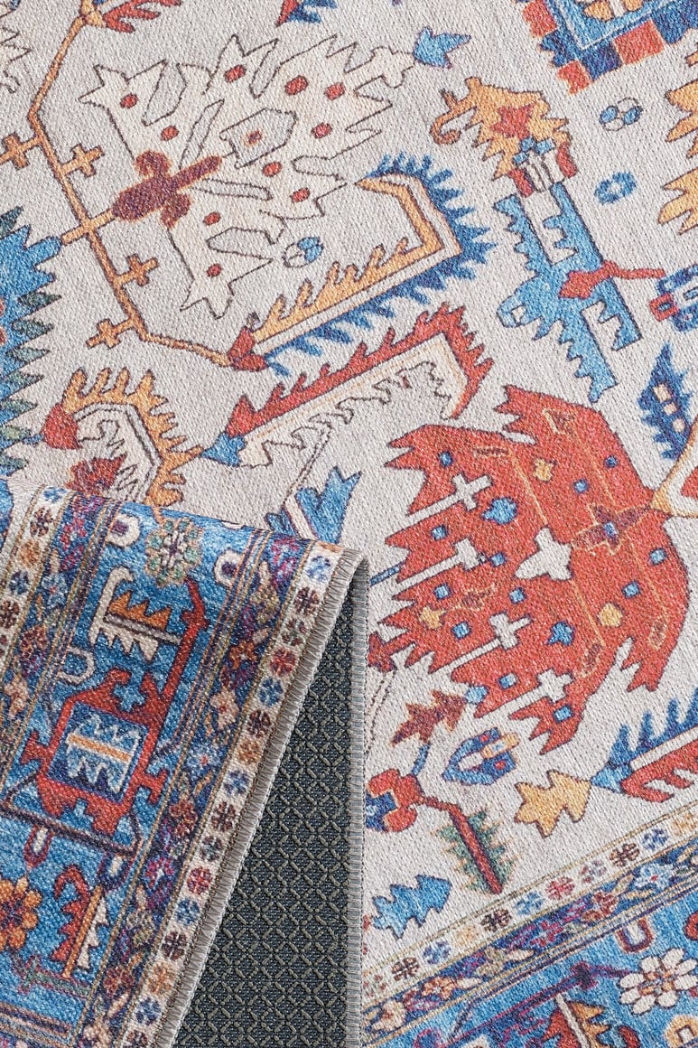 The Yonder Blue Cream Washable Rug - LCC3045 (Custom Size) features vibrant red, blue, gold, and white patterns with a dark, textured non-slip backing—ideal for high-traffic areas and easy to clean.