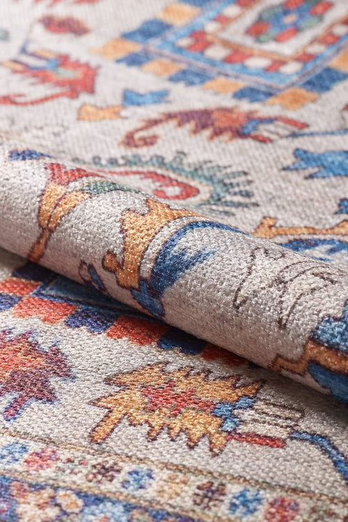 Load image 1 in gallery view. A close-up of the Yonder Blue Cream Washable Rug - LCC3045 (Custom Size) shows its vibrant geometric and floral patterns in red, blue, yellow, and beige—an ideal washable rug for high-traffic areas.