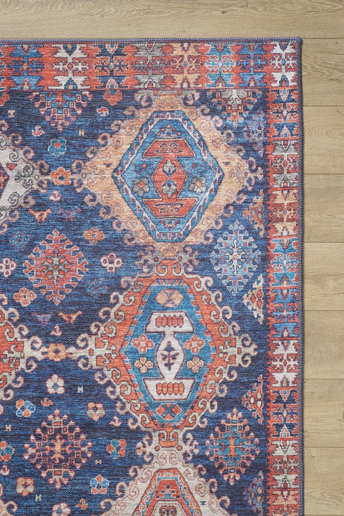 Bild 1 in Galerieansicht laden. The Zephyro Kilim-Design Washable Rug - LCC3008 features a colorful geometric pattern in red, blue, teal, and cream on a light background. Its diamond shapes and detailed border make it ideal for high-traffic areas.