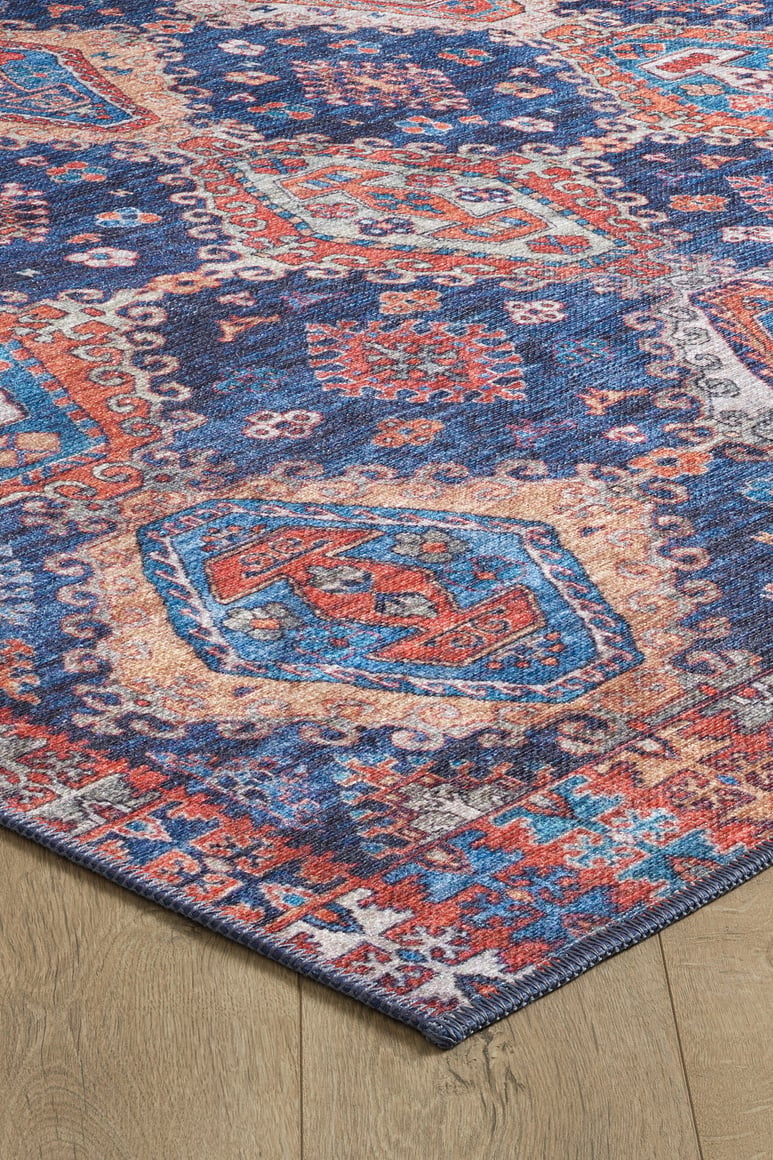 The Zephyro Kilim-Design Washable Rug - LCC3008 features geometric blue, red, orange, and cream patterns with a vintage look. Its durable and washable design makes it ideal for high-traffic areas. Available in custom sizes.