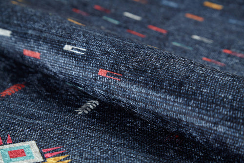 Load image 1 in gallery view. Close-up of the Wanderer's Way - Washable Rug - JR5101 (Custom Size) in dark blue, showcasing its woven, textured surface with small geometric patterns in red, white, yellow, and green. Thick and washable—perfect for high-traffic areas.