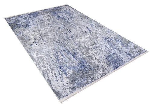 Bild 1 in Galerieansicht laden. The Abstract Oasis - Washable Rug - JR144 (Outlet) US features a rectangular shape with an abstract blue, gray, and white pattern. Ideal for high-traffic areas, it's shown angled on a white background.