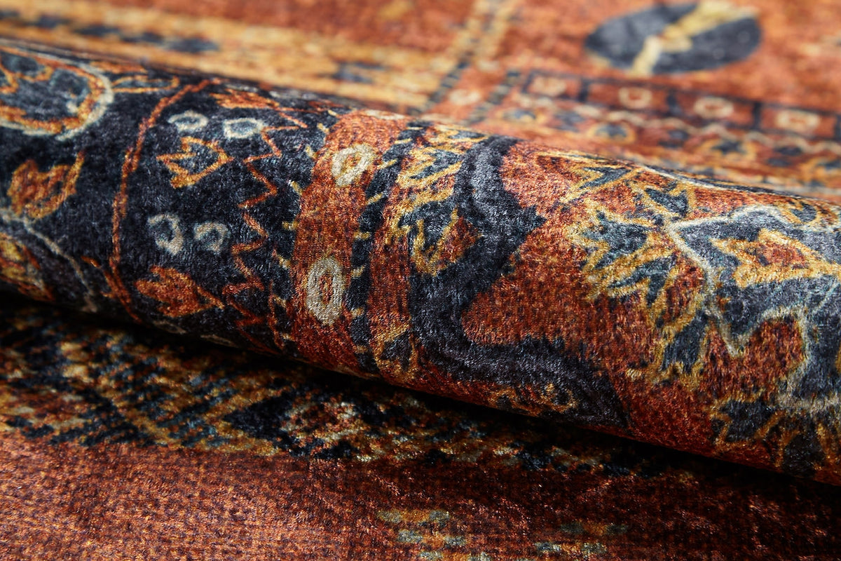 A close-up of the Ancient Palace - Washable Rug - JR1864, showing its intricate brown, gold, and dark blue floral and geometric patterns. The richly textured design is washable and ideal for high-traffic areas.