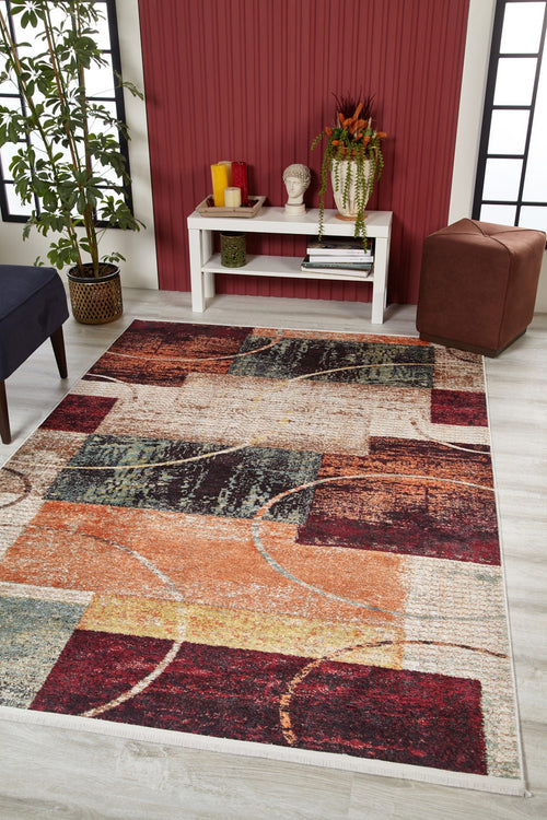 Load image 1 in gallery view. A modern living room featuring the Angular Beauty - Washable Rug - JR2002, ideal for high-traffic areas, with a red accent wall, white console table with decor, large potted plant, brown ottoman, and light wood flooring.