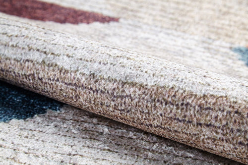 Load image 1 in gallery view. Close-up of the Asymmetrical Wonder - Washable Rug - JR1725, beige and brown with subtle blue and reddish-brown accents. Its woven, washable design is ideal for high-traffic areas and perfect for allergy-sensitive homes.