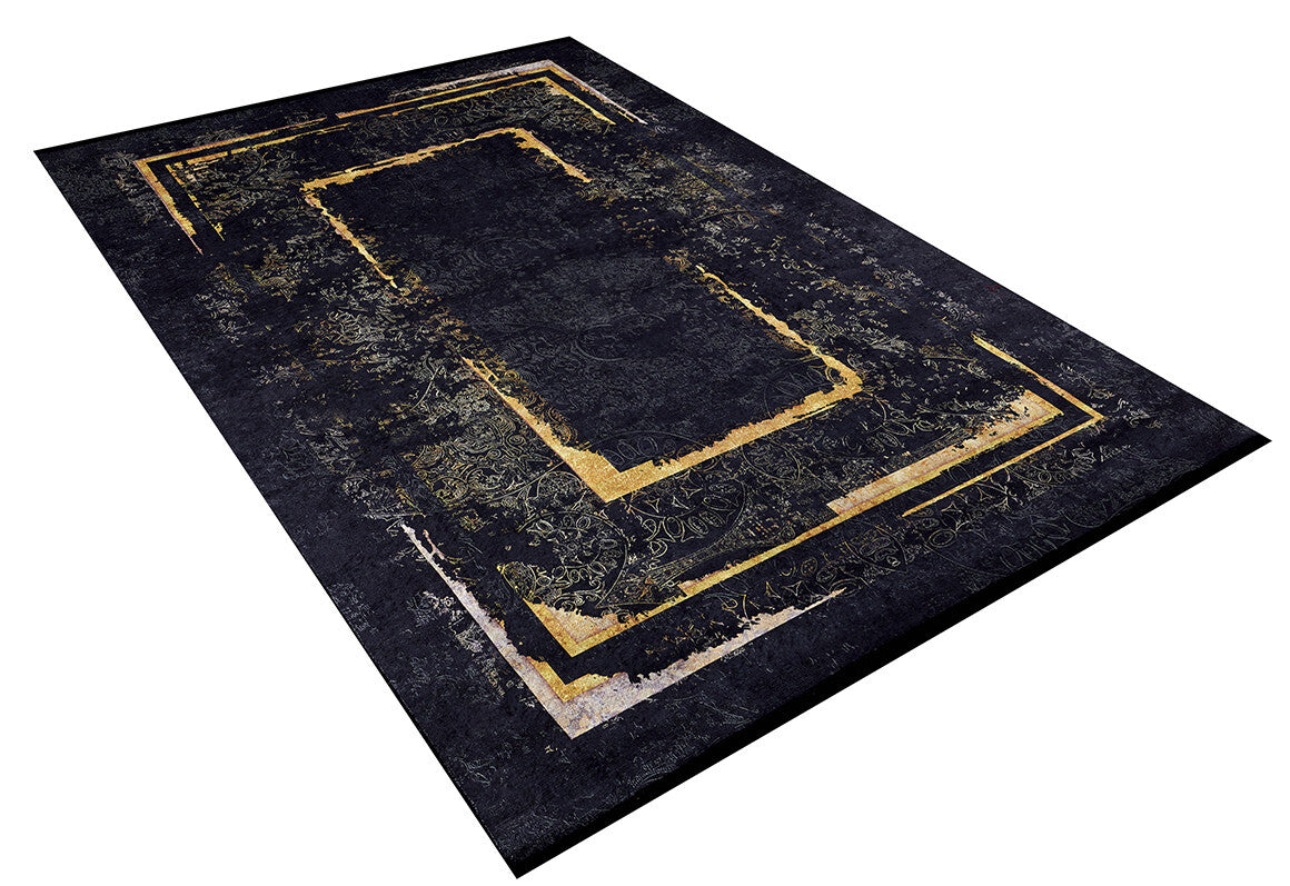 The Azure Glow - Washable Rug - JR1337 features a modern black design with a dark, textured background and layered gold and beige geometric borders—perfect for high-traffic areas. Shown angled on a white backdrop.