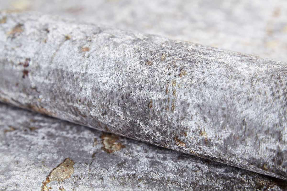 Close-up of the Berry Blossom - Washable Rug - JR1818 in silver-grey, featuring a textured flat weave with subtle reflective qualities and irregular patterns reminiscent of crushed velvet.