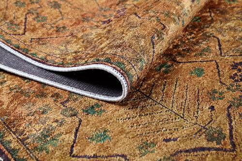Load image 1 in gallery view. A close-up of the Blossom Breeze - Washable Rug - JR1752 highlights its brown patterned flat weave with green and purple accents, textured surface, and folded underside featuring white stitched borders.