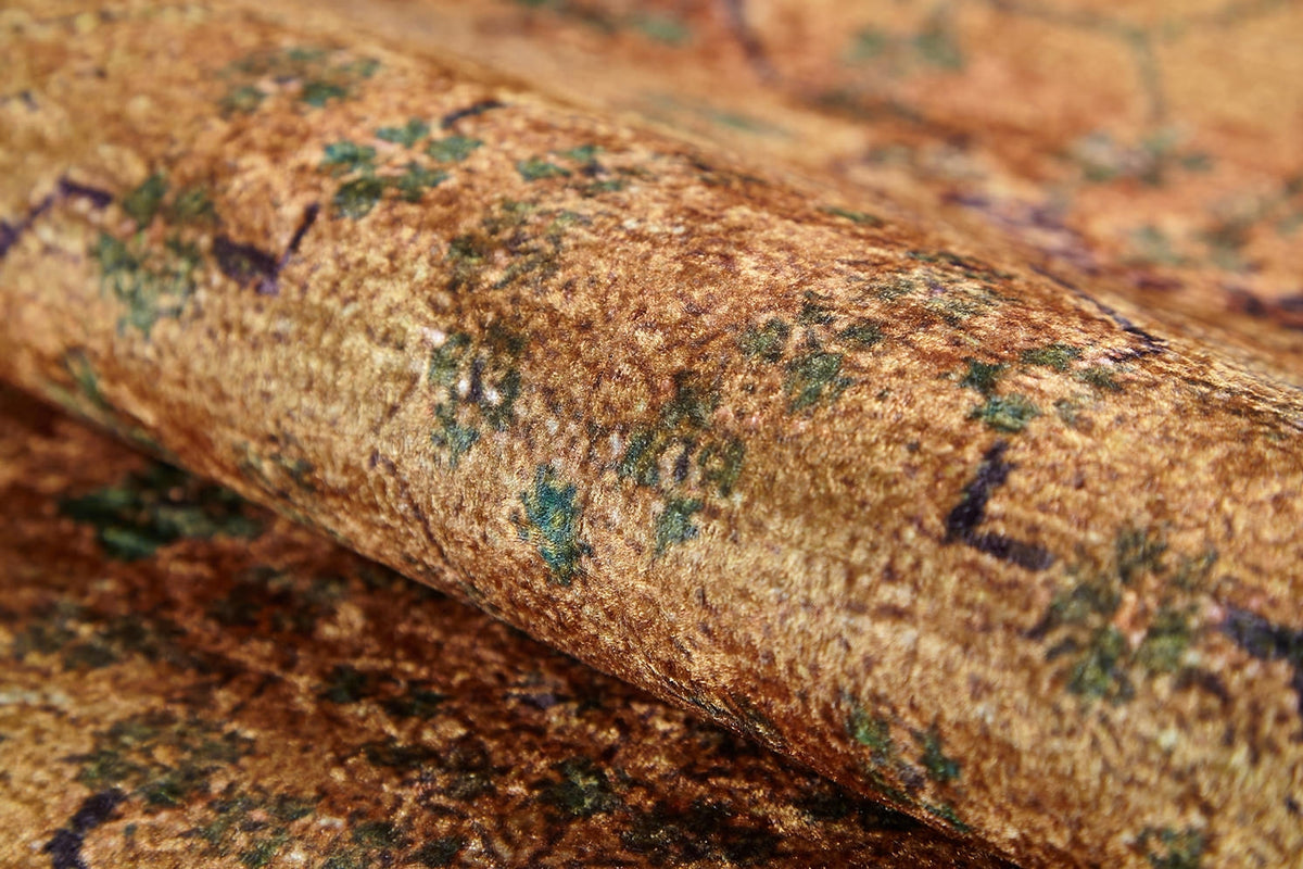 Close-up of Blossom Breeze - Washable Rug (JR1752), featuring a brown and green flat weave with a mottled, vintage pattern and subtle blue and purple accents.