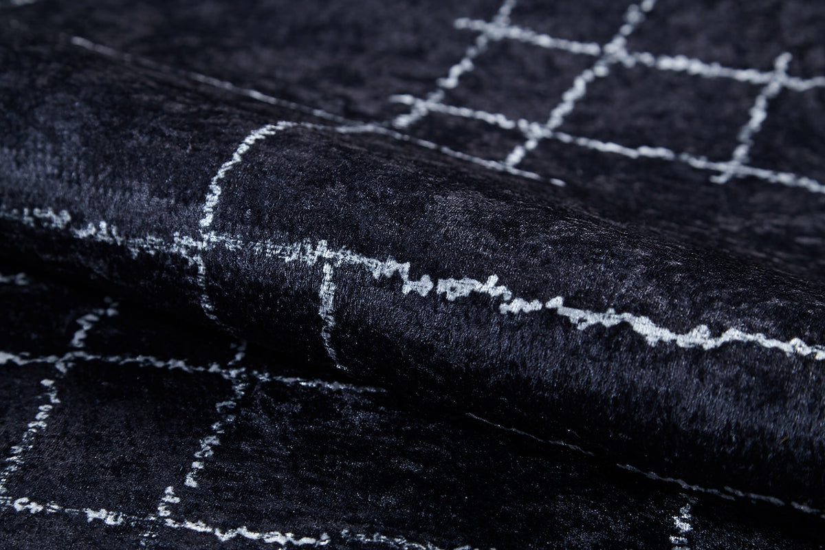 Close-up of Bohemian Illusion - Washable Rug - JR1953, featuring dark, textured flat weave with a checkered grid of uneven white lines. The soft material has a slight sheen and gentle folds that catch the light.
