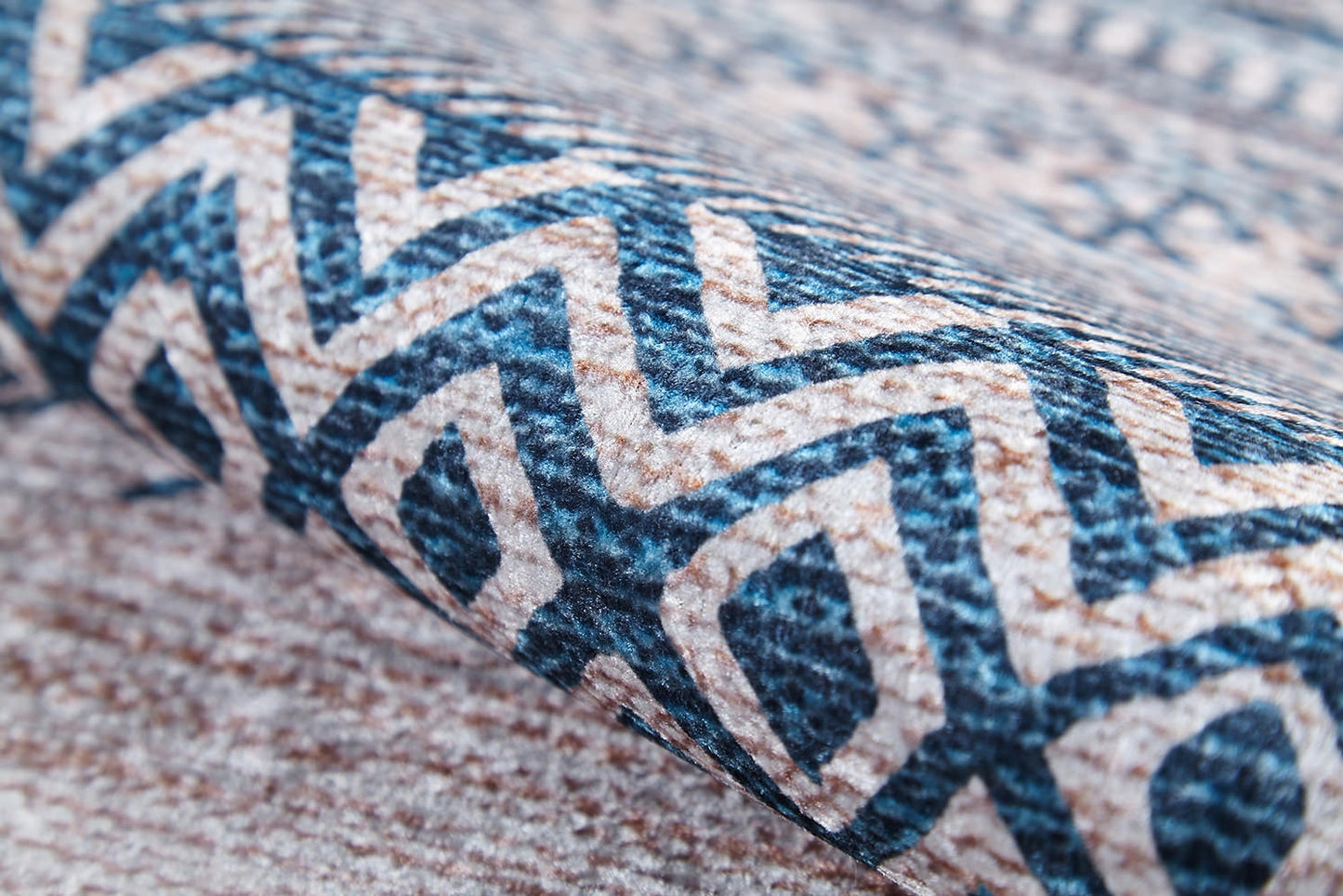 A close-up of the Bohemian Nights - Washable Rug (JR1585), showcasing its blue and beige geometric zigzag and diamond pattern—perfect for high-traffic areas.