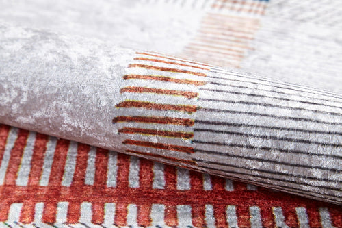 Load image 1 in gallery view. A close-up of the Bohemian Nightscape - Washable Rug (JR1701) shows its soft, textured fabric and modern geometric pattern in red, orange, and beige on a white-gray background—durable and stylish for high-traffic areas.
