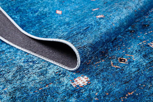Load image 1 in gallery view. A close-up of the Bohemian Whirlwind - Washable Rug - JR1989 in blue, featuring small geometric designs and a textured gray underside—ideal for high-traffic areas, easy to maintain, and finished with neatly stitched edges.