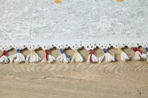 Load image 1 in gallery view. Close-up of the Boho Chic - Washable Rug - JR5103 in light gray with white, red, blue, and beige tasseled fringe, placed on a wooden floor—perfect for high-traffic areas and easy to clean.