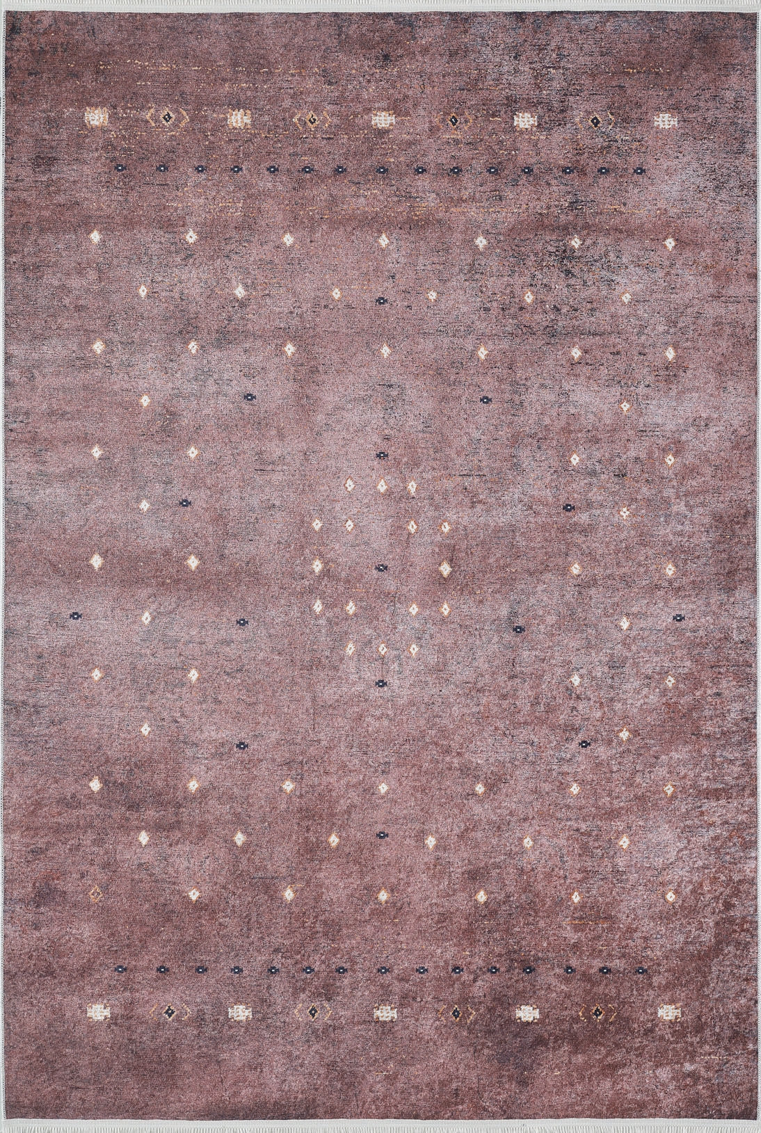 The Boho Magic - Washable Rug - JR1993 features a rectangular, washable design with a faded mauve background and small geometric motifs in white, yellow, and dark blue—ideal for allergy-sensitive homes wanting style beyond typical bronze and brown rugs.