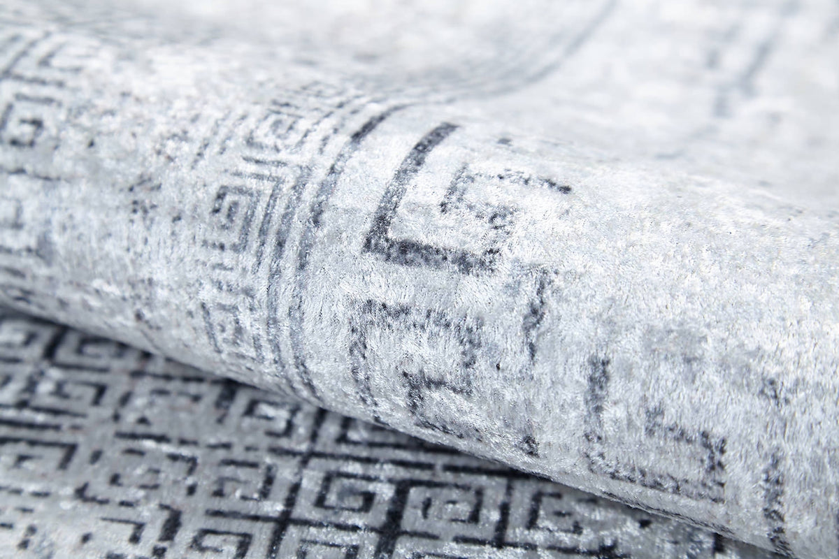 A close-up of the Bold Borderline - Washable Rug - JR1984 in gray-anthracite, featuring a subtle geometric Greek key pattern and soft texture—durable and stylish for high-traffic areas.