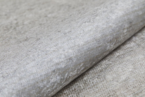 Load image 1 in gallery view. A close-up of Cinnamon Swirl - Washable Rug - JR425 shows its gray, textured, metallic-finish surface—resembling recycled fiber and crafted for high-traffic areas, combining durability with washable convenience.