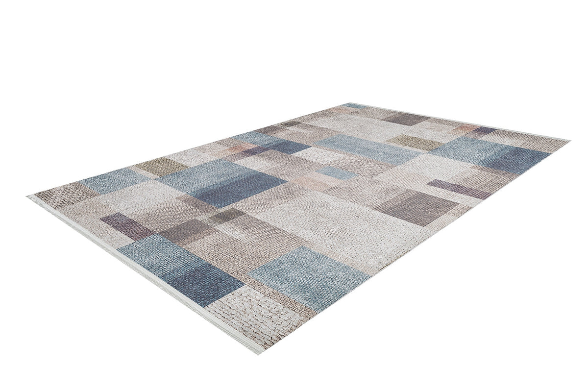 The Classic Check - Washable Rug - JR1955 features a geometric patchwork pattern in blue, beige, gray, and brown. This rectangular rug is ideal for high-traffic areas and is shown on a white background.