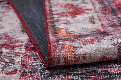 Load image 1 in gallery view. A close-up of the Classic Revival - Washable Rug - JR1374 in red, beige, and orange showcases its textured surface and flipped corner revealing the dark, non-slip backing—perfect for high-traffic areas.