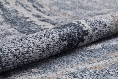 Load image 1 in gallery view. Close-up of the Classic and Bold - Washable Rug - JR1529, featuring a rolled, textured gray-anthracite surface with a soft, subtly distressed gray, black, and white abstract pattern—perfect for high-traffic areas.