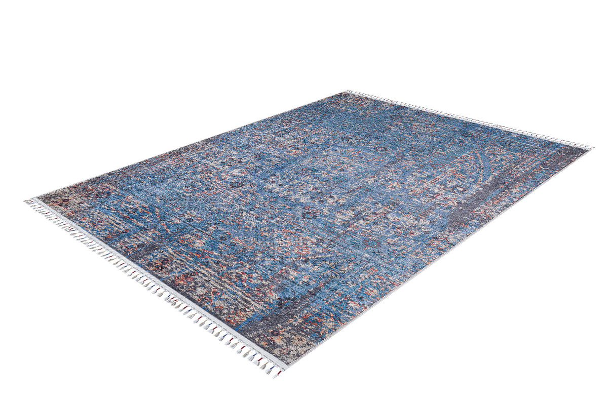 The Desert Diamond - Washable Rug - JR5071 is a rectangular rug with a blue, red, and beige intricate pattern, short white fringes on the edges, and is perfect for high-traffic areas. Shown on a white background.