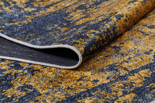 Load image 1 in gallery view. Close-up of Diagonal Dash - Washable Rug - JR1310: a modern yellow-gold rug featuring a textured abstract dark blue pattern with visible stitching and curled edge showing the underside—ideal for high-traffic areas.