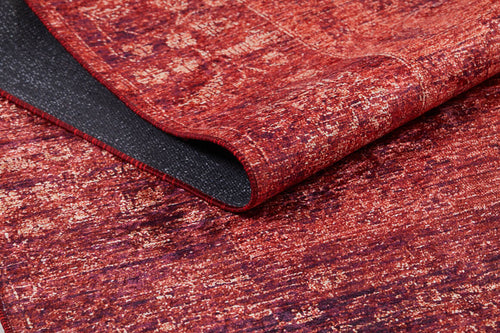 Load image 1 in gallery view. A close-up of the Dynasty Dream - Washable Rug - JR160 in red and gold, showing its textured surface and a folded edge that reveals the black non-slip backing.