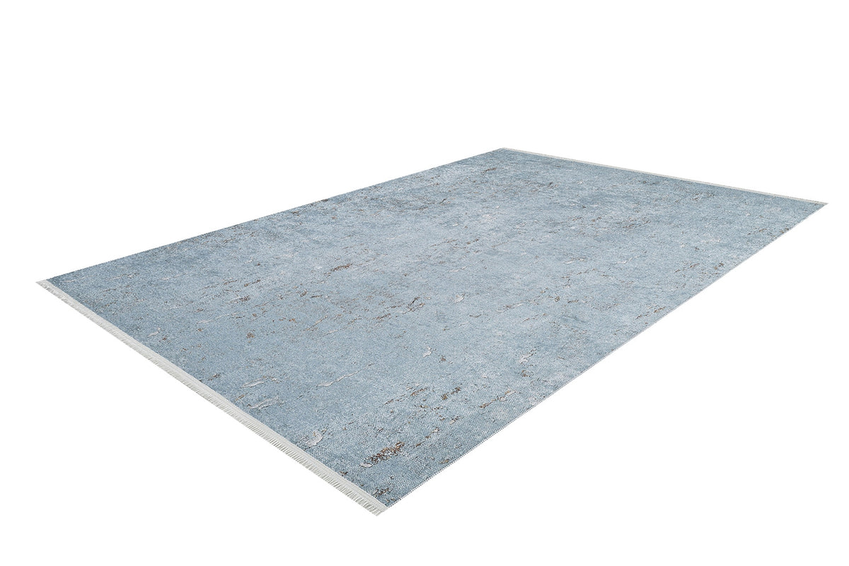 The Earthy Sands - Washable Rug - JR1819 is a rectangular light blue rug with subtle distressed patterns and fringe on the short edges, ideal for high-traffic areas and shown on a white background.
