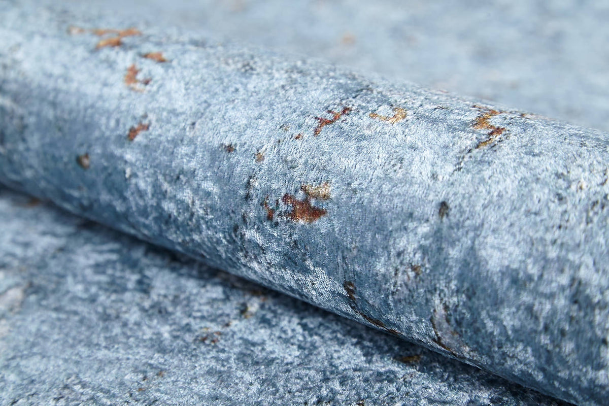 A close-up of the Earthy Sands - Washable Rug - JR1819, featuring a textured blue-grey surface with brown and rust patches; perfect for high-traffic areas and easy to clean.