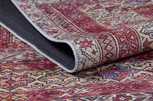 Load image 1 in gallery view. A close-up of the Elegant Embellishments - Washable Rug - JR43 showcases its red, cream, and gold geometric and floral patterns, with a folded corner revealing the black nonslip backing—ideal for high-traffic areas.