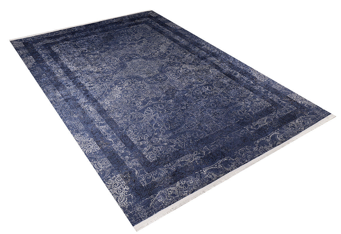 The Elegant and Modern - Washable Rug - JR1297 is a large rectangular blue rug with ornate blue and white patterns, a detailed border, and central motifs. Perfect for high-traffic areas, it's shown on a white background.